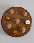 The top view of a 2023 Father's Day cake entremet topped with 5 teardrop piping and 3 mousse balls