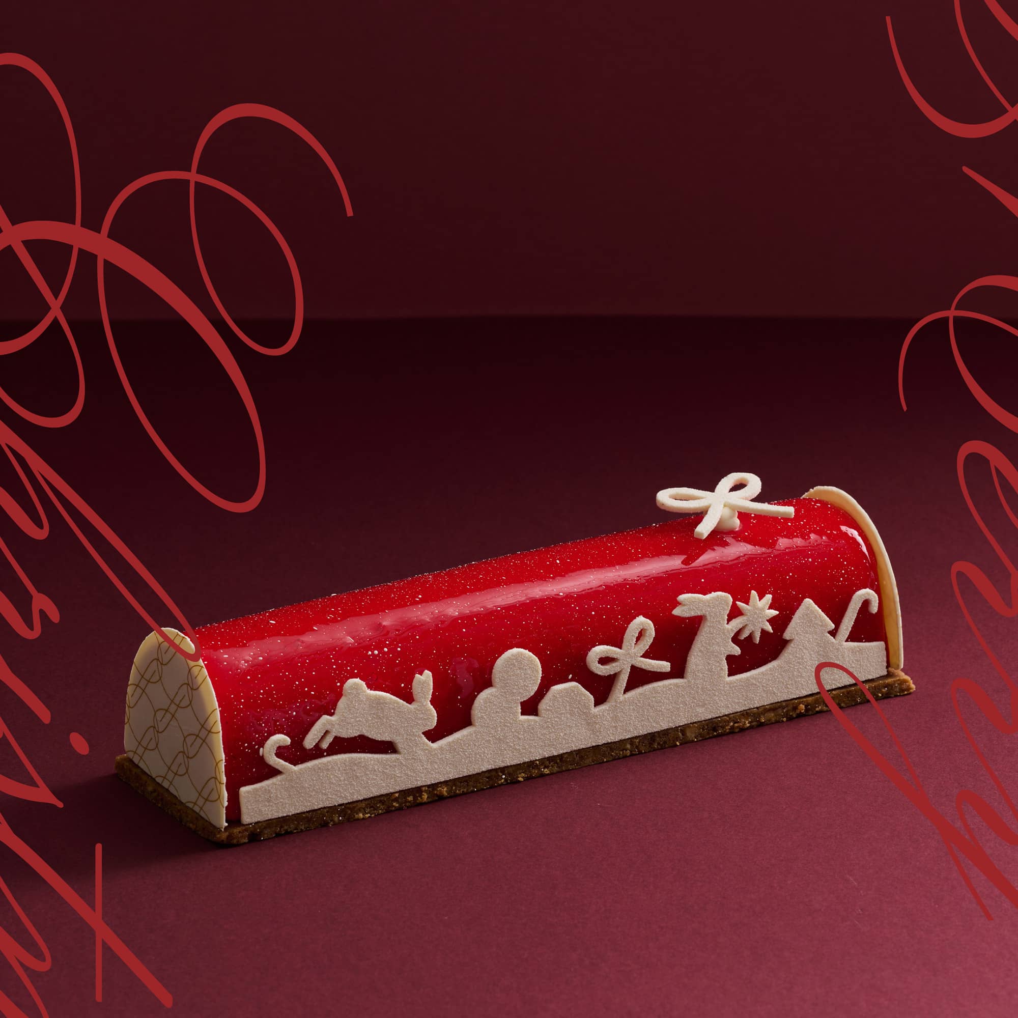 A Red Berries Fromage Blanc cake as this year's 2023 Christmas log cake coated in red glaze and decorated with Christmas themed white chocolate