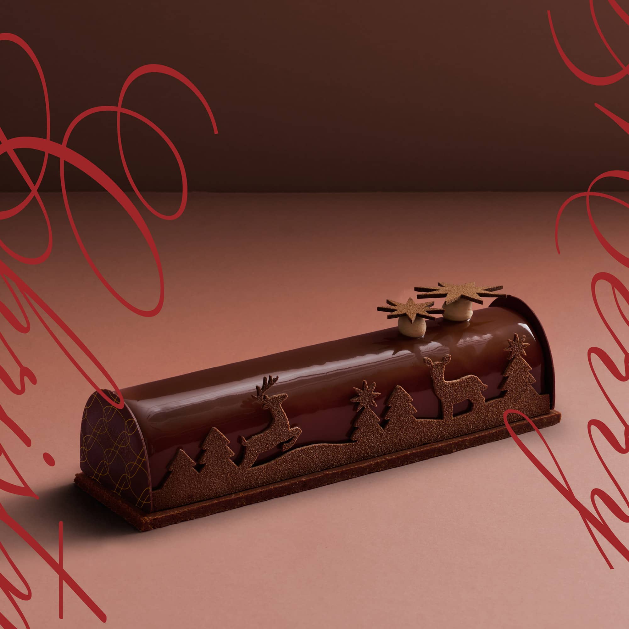 A Valrhona dark chocolate log cake as a 2023 Christmas cake decorated with Christmas themed chocolate decorations