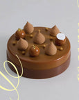 A brown 2023 Father's day cake with a chocolate collar, and topped with 5 teardrop piping and 3 chocolate mousse balls