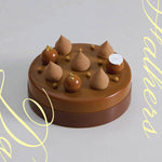 A brown 2023 Father's day cake with a chocolate collar, and topped with 5 teardrop piping and 3 chocolate mousse balls