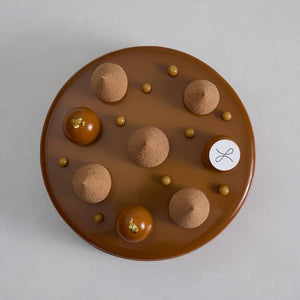 The top view of a 2023 Father's Day cake entremet topped with 5 teardrop piping and 3 mousse balls
