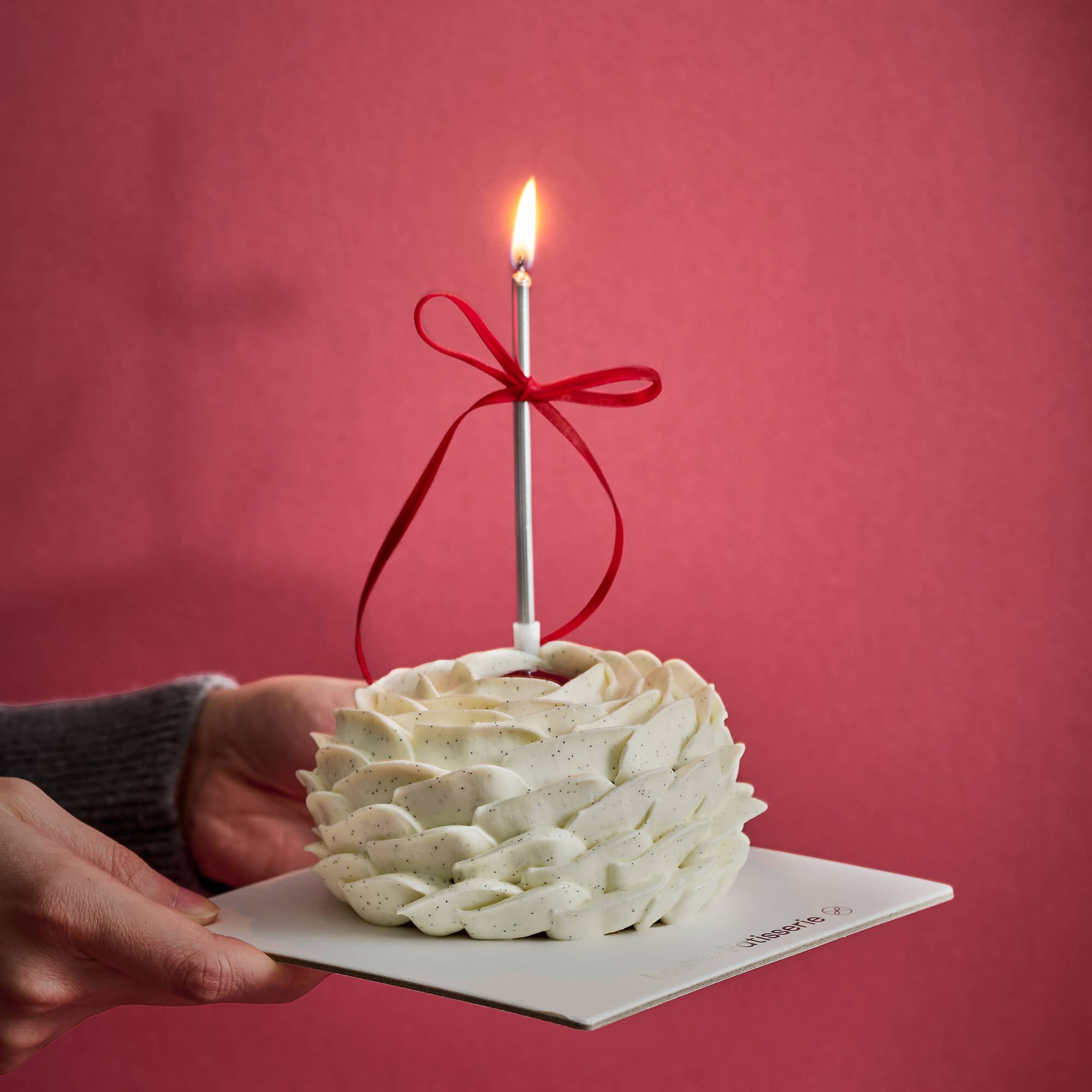 2024 Valentines Cake with a lit candle